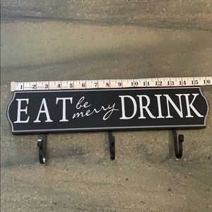 Eat, drink, be merry sign with three hooks
